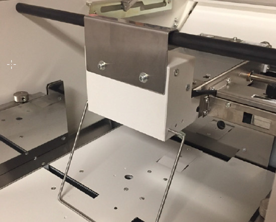 BELT FEED SYSTEM - A belt fed, air suction system allows trouble-free feeding of coated stock