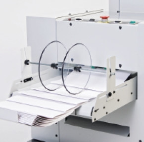 The powered exit conveyor on the bookletmaker or trimmer stacks booklets neatly.